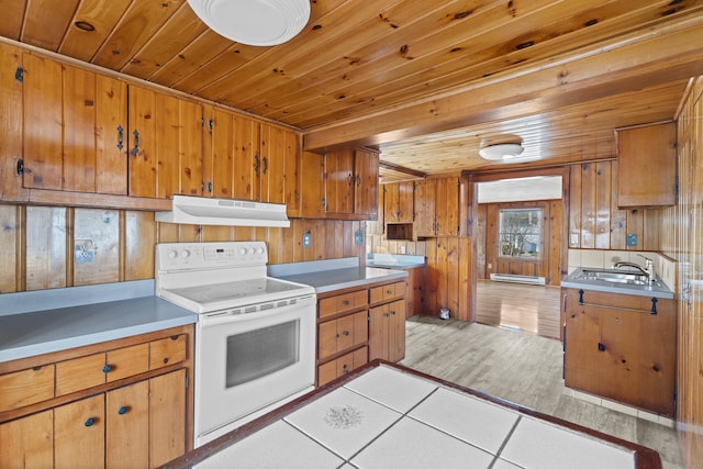 kitchen with brown cabinetry, under cabinet range hood, wooden ceiling, white range with electric stovetop, and a sink