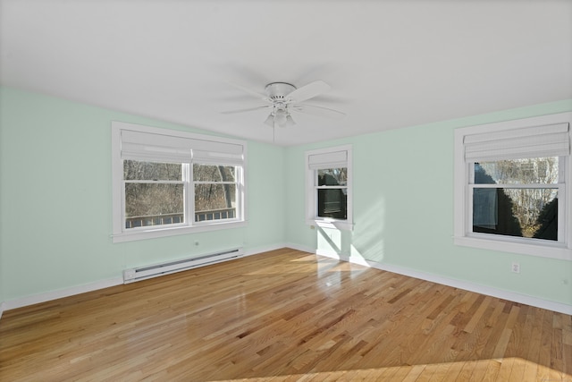 unfurnished room with wood finished floors, baseboards, baseboard heating, and ceiling fan