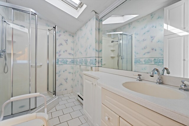 bathroom featuring tile patterned flooring, a shower stall, wallpapered walls, vaulted ceiling with skylight, and vanity