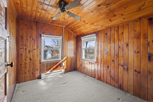 carpeted spare room featuring a baseboard heating unit, ceiling fan, wood walls, wood ceiling, and lofted ceiling