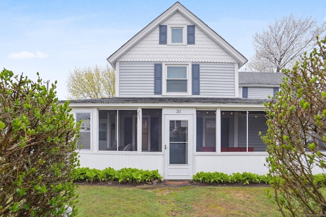 31 Old Colony Rd, Old Lyme, CT 06371 - view of front of home with roof with shingles, a front yard, and a sunroom