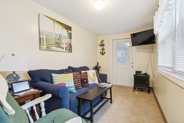 31 Old Colony Rd, Old Lyme, CT 06371 - living room featuring light tile patterned flooring, a wood stove, and baseboards