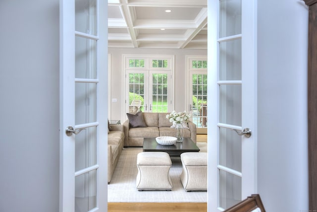 sunroom with beam ceiling, coffered ceiling, and french doors
