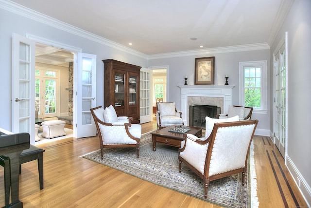 sitting room featuring a fireplace, wood finished floors, plenty of natural light, crown molding, and recessed lighting