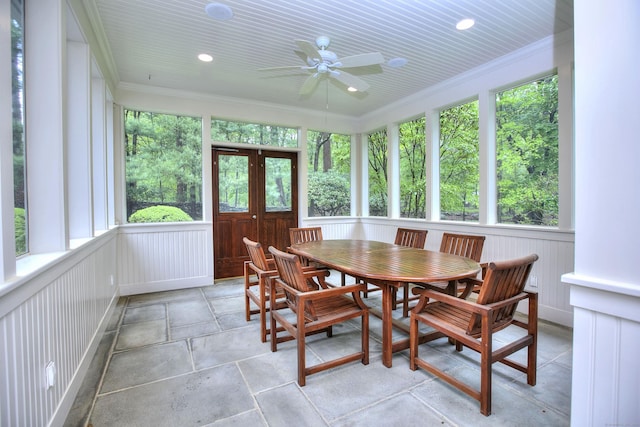 sunroom with plenty of natural light, french doors, ornamental molding, stone finish flooring, and recessed lighting