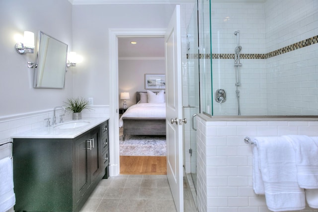 full bathroom with ornamental molding, ensuite bathroom, a stall shower, vanity, and tile patterned flooring
