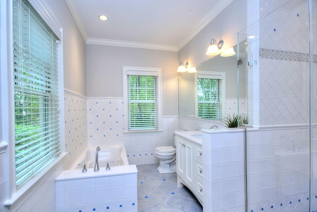 bathroom featuring tile walls, tile patterned floors, a garden tub, vanity, and wainscoting