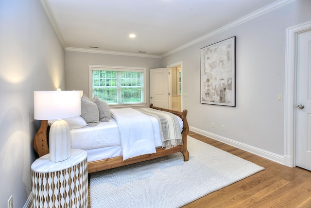 bedroom featuring wood finished floors, baseboards, ornamental molding, and recessed lighting