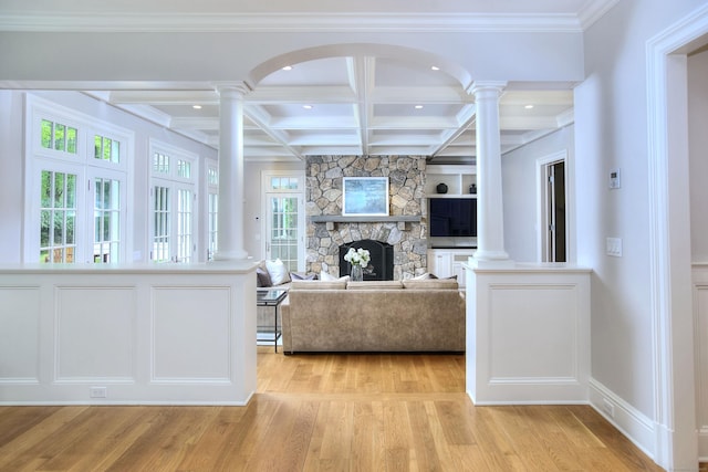 living area with decorative columns, recessed lighting, light wood-style flooring, beam ceiling, and coffered ceiling