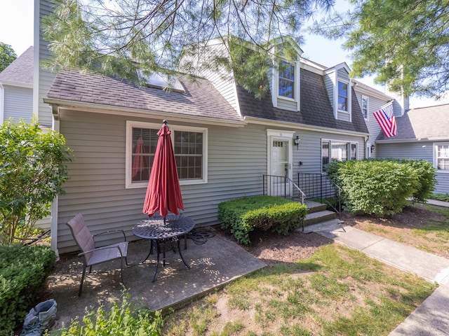 19 Prospect Rdg Apt 16, Ridgefield, CT 06877 - back of house featuring a shingled roof and a patio area