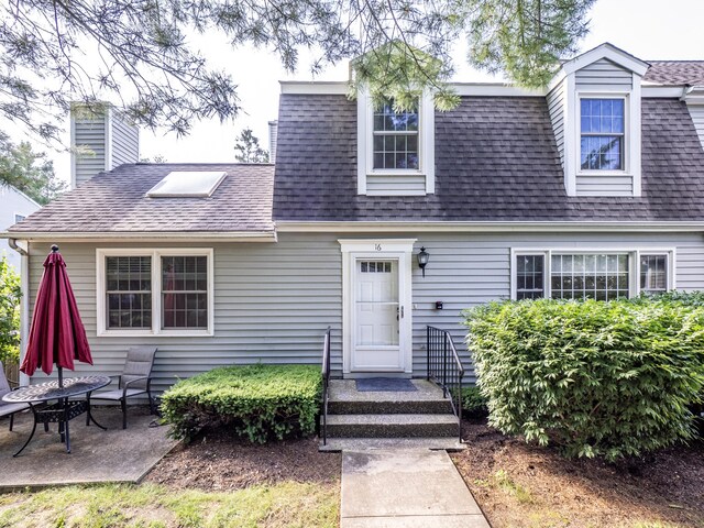 19 Prospect Rdg Apt 16, Ridgefield, CT 06877 - view of front of house with a shingled roof, a chimney, and a patio