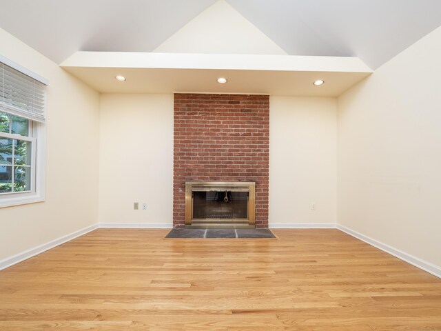 19 Prospect Rdg Apt 16, Ridgefield, CT 06877 - unfurnished living room with vaulted ceiling, wood finished floors, a brick fireplace, and recessed lighting