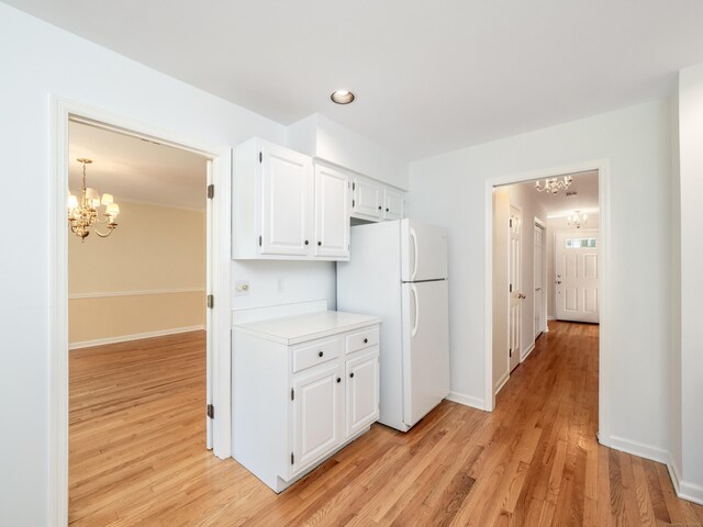 19 Prospect Rdg Apt 16, Ridgefield, CT 06877 - kitchen with a chandelier, freestanding refrigerator, light wood-type flooring, and recessed lighting