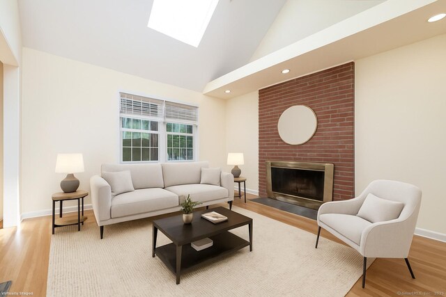 19 Prospect Rdg Apt 16, Ridgefield, CT 06877 - living room with high vaulted ceiling, wood finished floors, a skylight, a brick fireplace, and recessed lighting