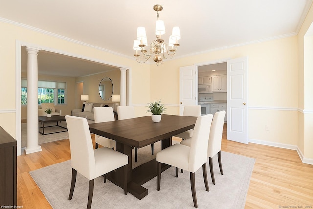 19 Prospect Rdg Apt 16, Ridgefield, CT 06877 - dining space with ornate columns, light wood-style flooring, ornamental molding, and a chandelier