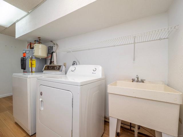19 Prospect Rdg Apt 16, Ridgefield, CT 06877 - laundry room with light wood-style floors, water heater, and separate washer and dryer