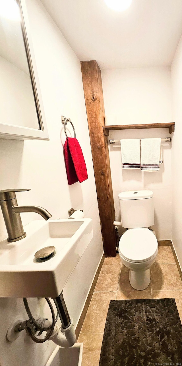 half bath with toilet and baseboards
