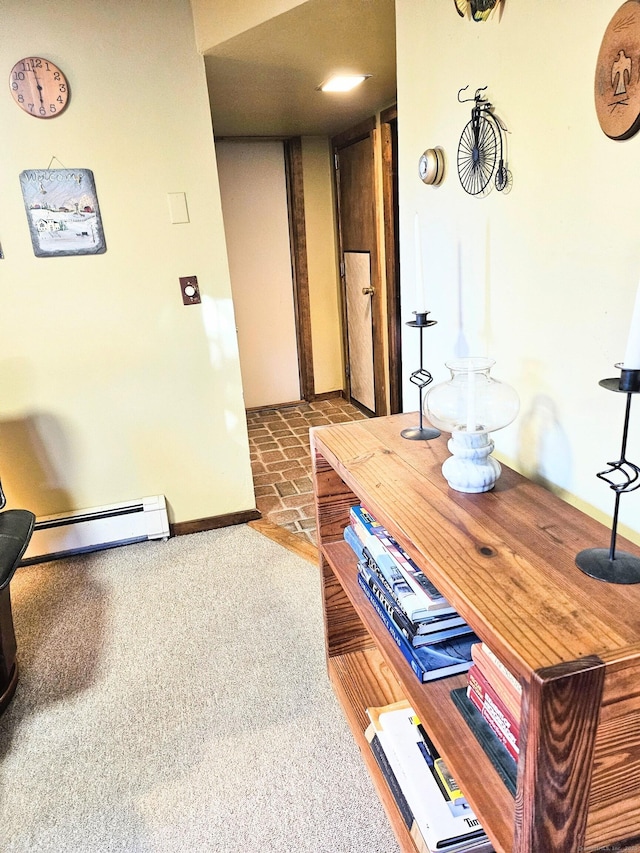 corridor featuring a baseboard radiator and baseboards