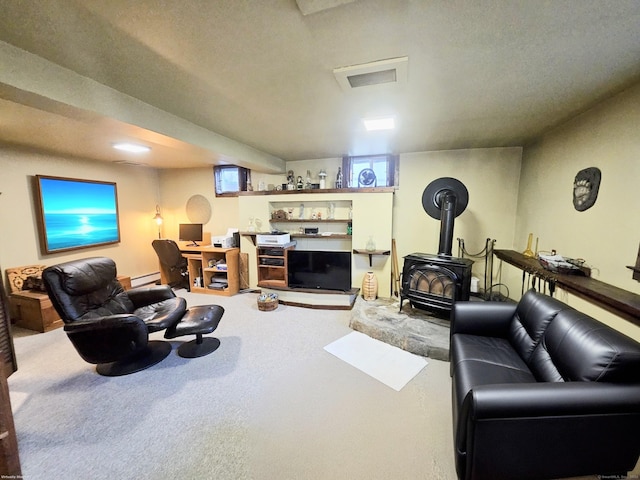 living room with carpet, a baseboard heating unit, and a wood stove