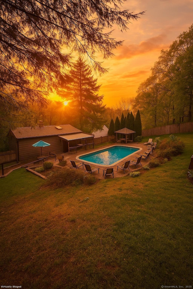 view of pool with fence, a gazebo, a fenced in pool, and a lawn