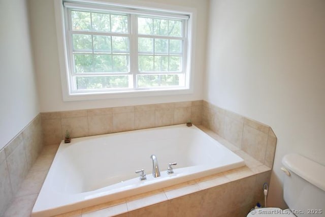 bathroom with toilet and a bath