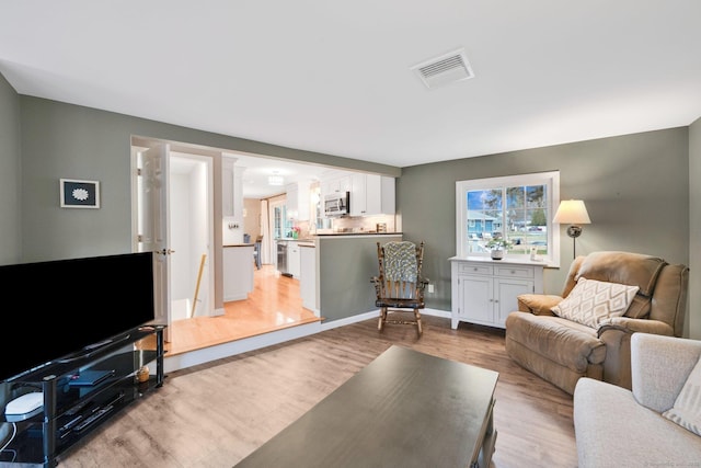 12 Nevins Ave, Enfield, CT 06082 - living room with light wood-style floors and baseboards
