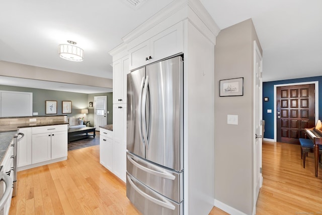 12 Nevins Ave, Enfield, CT 06082 - kitchen featuring freestanding refrigerator, light wood-style flooring, and white cabinetry