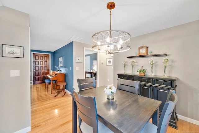 12 Nevins Ave, Enfield, CT 06082 - dining space featuring a chandelier and light wood finished floors
