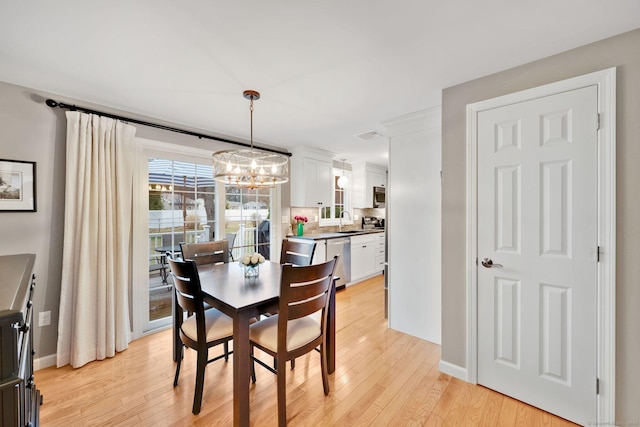 12 Nevins Ave, Enfield, CT 06082 - dining room featuring a chandelier and light wood finished floors