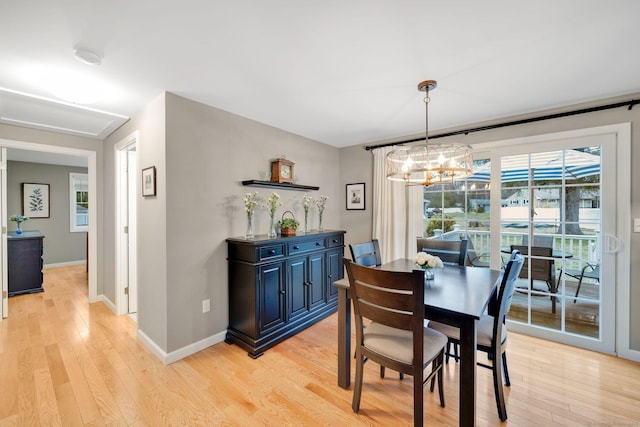12 Nevins Ave, Enfield, CT 06082 - dining area featuring light wood-style floors and a chandelier