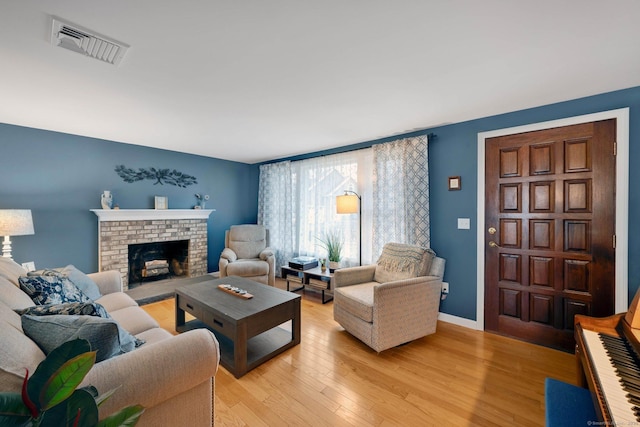 12 Nevins Ave, Enfield, CT 06082 - living room featuring light wood-style floors and a brick fireplace