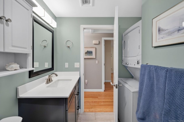 12 Nevins Ave, Enfield, CT 06082 - bathroom with stacked washing machine and dryer and vanity