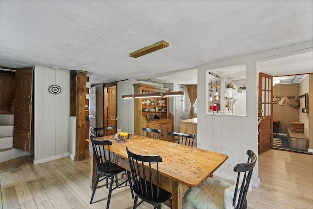 58 Middle Haddam Rd, East Hampton, CT 06456 - dining space featuring light wood-style floors, stairs, a bar, and wooden walls