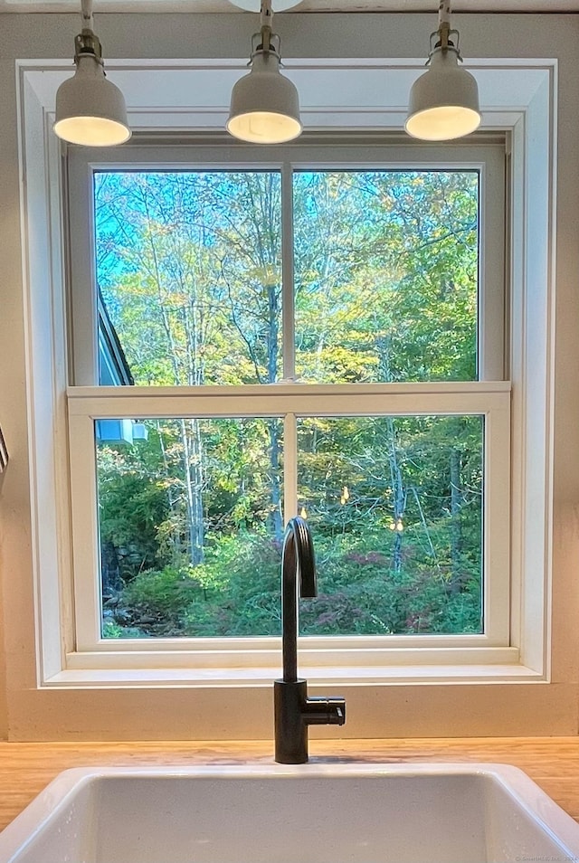 58 Middle Haddam Rd, East Hampton, CT 06456 - kitchen view of a sink, decorative light fixtures, and light countertops