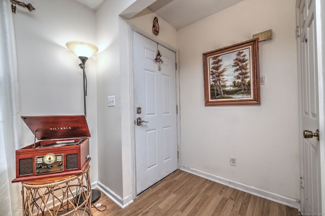 interior space with baseboards and light wood-style flooring
