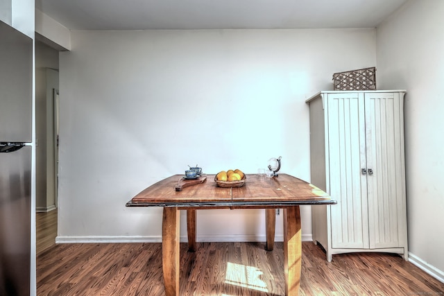 home office with baseboards and wood finished floors