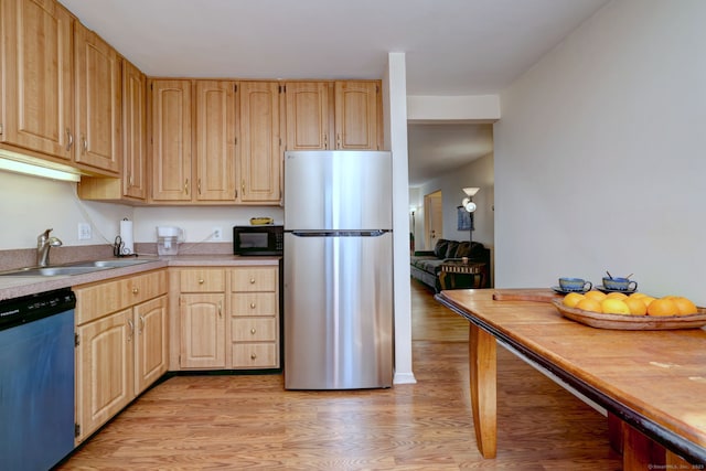 kitchen with light brown cabinets, a sink, black microwave, dishwashing machine, and freestanding refrigerator