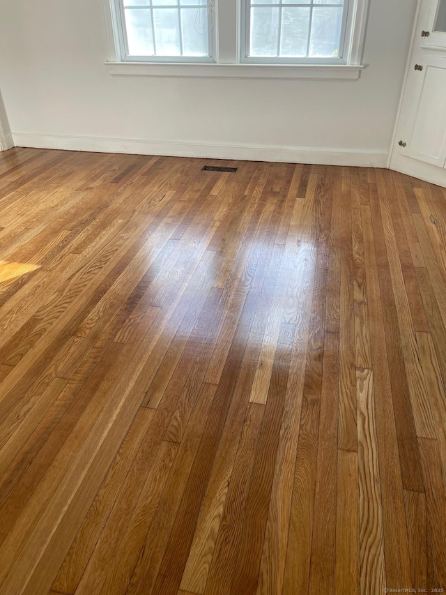 interior details featuring visible vents, baseboards, and wood finished floors