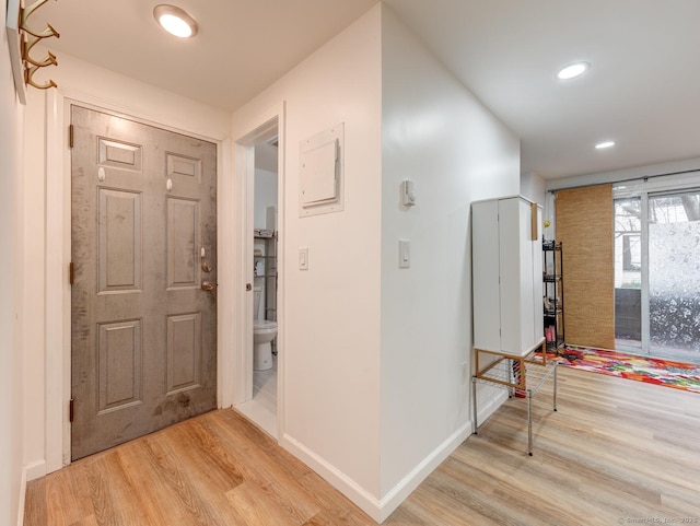 foyer entrance featuring recessed lighting, baseboards, and light wood-type flooring