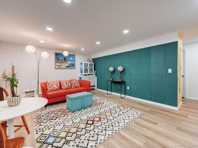 living room with wallpapered walls, recessed lighting, wood finished floors, and baseboards