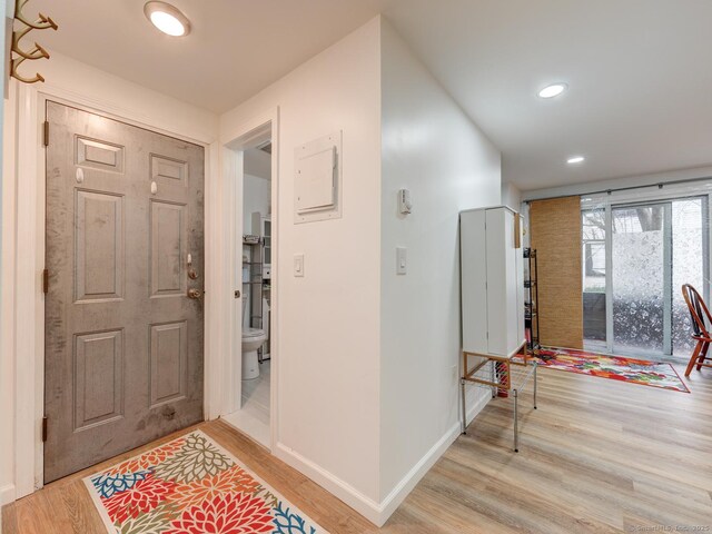 foyer with recessed lighting, baseboards, and wood finished floors