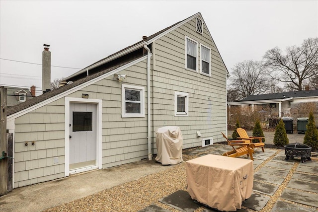 back of house featuring a patio area and an outdoor fire pit