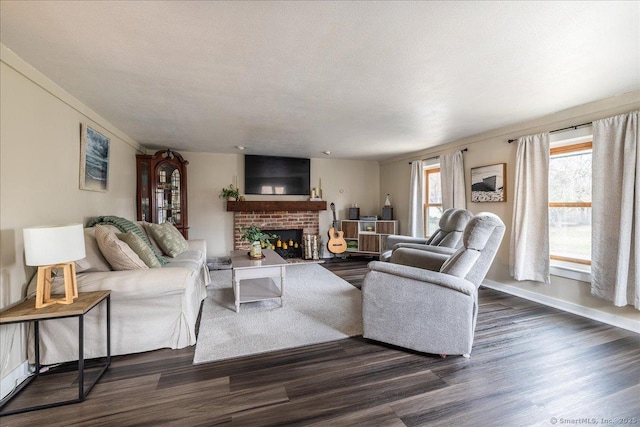 living room with a textured ceiling, a fireplace, dark wood-style flooring, and baseboards