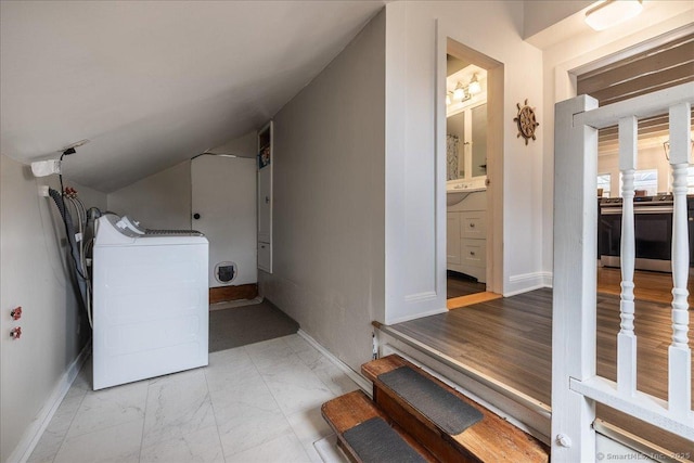 interior space featuring laundry area, washer / dryer, marble finish floor, and baseboards