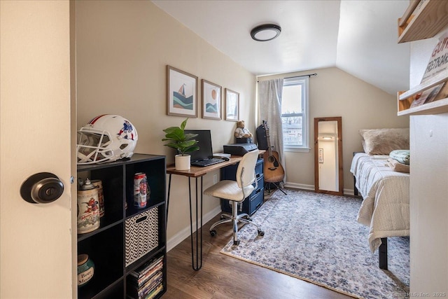 bedroom with baseboards, wood finished floors, and vaulted ceiling