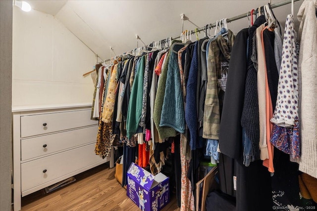 walk in closet featuring lofted ceiling and wood finished floors