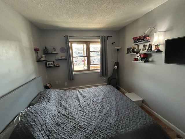 173 Russo Ave Unit 610, East Haven, CT 06513 - bedroom with a baseboard radiator and a textured ceiling
