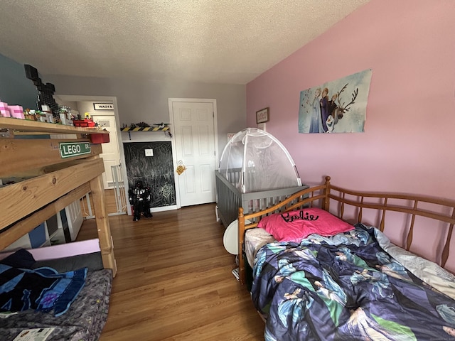 173 Russo Ave Unit 610, East Haven, CT 06513 - bedroom with wood finished floors and a textured ceiling