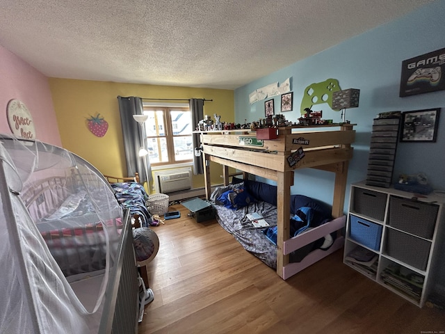 173 Russo Ave Unit 610, East Haven, CT 06513 - bedroom with wood finished floors, a textured ceiling, and a workshop area