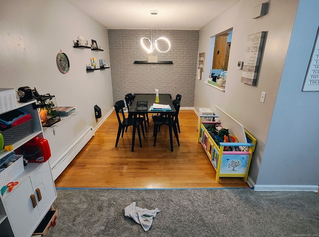 173 Russo Ave Unit 610, East Haven, CT 06513 - carpeted dining room featuring a baseboard heating unit, wood finished floors, and a chandelier